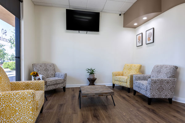 Waiting area by window with chairs and table at Higher Ground Dentistry in Upland, CA