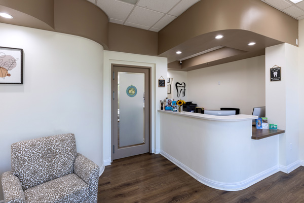 Front desk area with lounge chair at Higher Ground Dentistry in Upland, CA