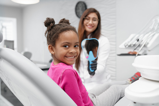 smiling kid turning around in the dental chair