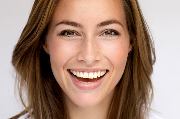 Beautiful woman smiling after teeth whitening in Upland by Dr. Sikka