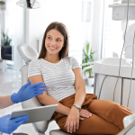 Relaxed woman in modern dental office debunking cosmetic dentistry myths about painful uncomfortable procedures