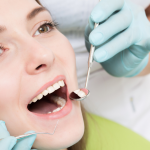 Professional teeth cleaning appointment with dental hygienist using cleaning tools on patient