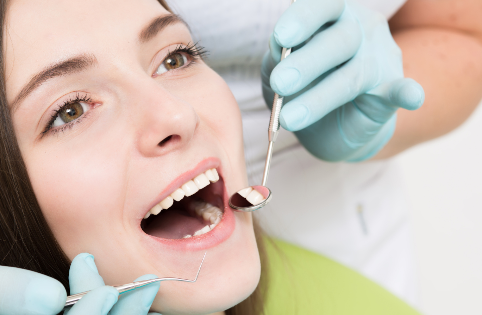 Professional teeth cleaning appointment with dental hygienist using cleaning tools on patient