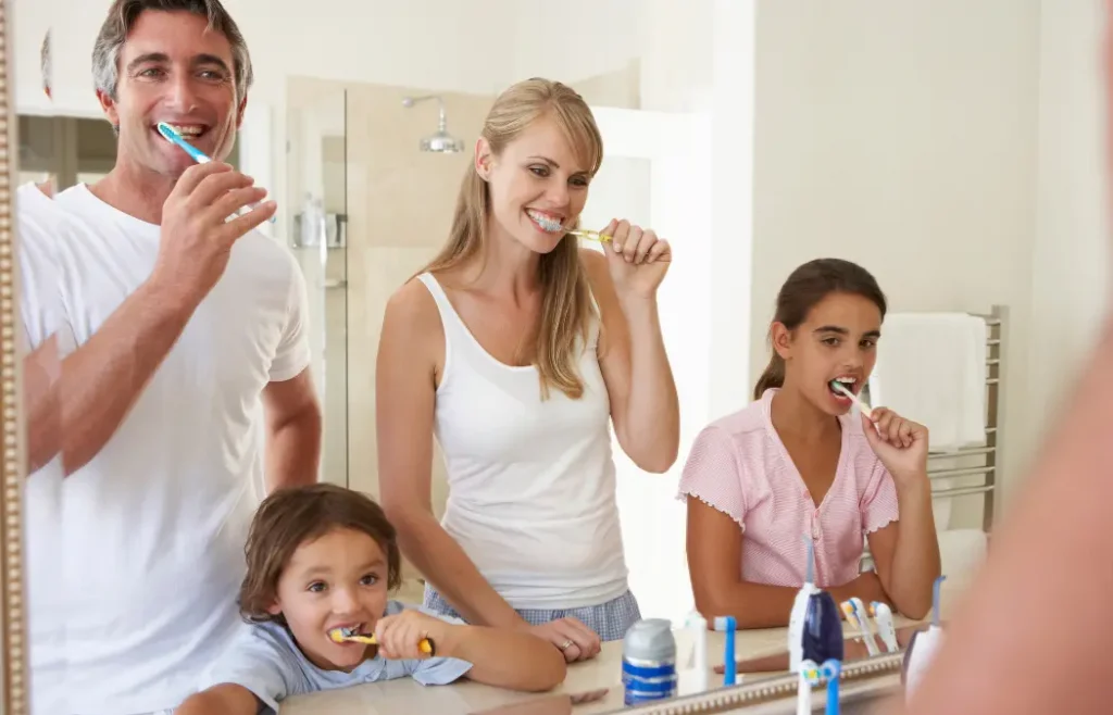 Family brushing teeth together for Dental Hygiene Month at Higher Ground Dentistry Upland