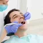 Dentist examining patient before dental benefits expiring deadline at Upland family dental office