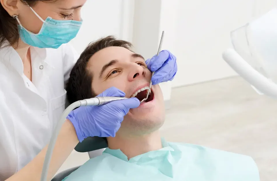 Dentist examining patient before dental benefits expiring deadline at Upland family dental office