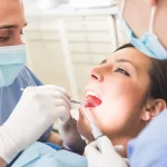 Dentist examining patient's teeth at Higher Ground Dentistry in Upland CA discussing at-home orthodontic trends myths versus facts