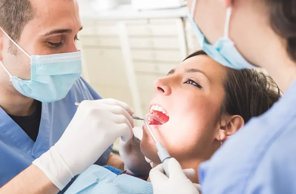 Dentist examining patient's teeth at Higher Ground Dentistry in Upland CA discussing at-home orthodontic trends myths versus facts