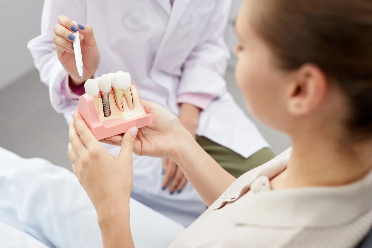 Dentist explaining dental implant procedure to patient at Higher Ground Dentistry in Upland CA