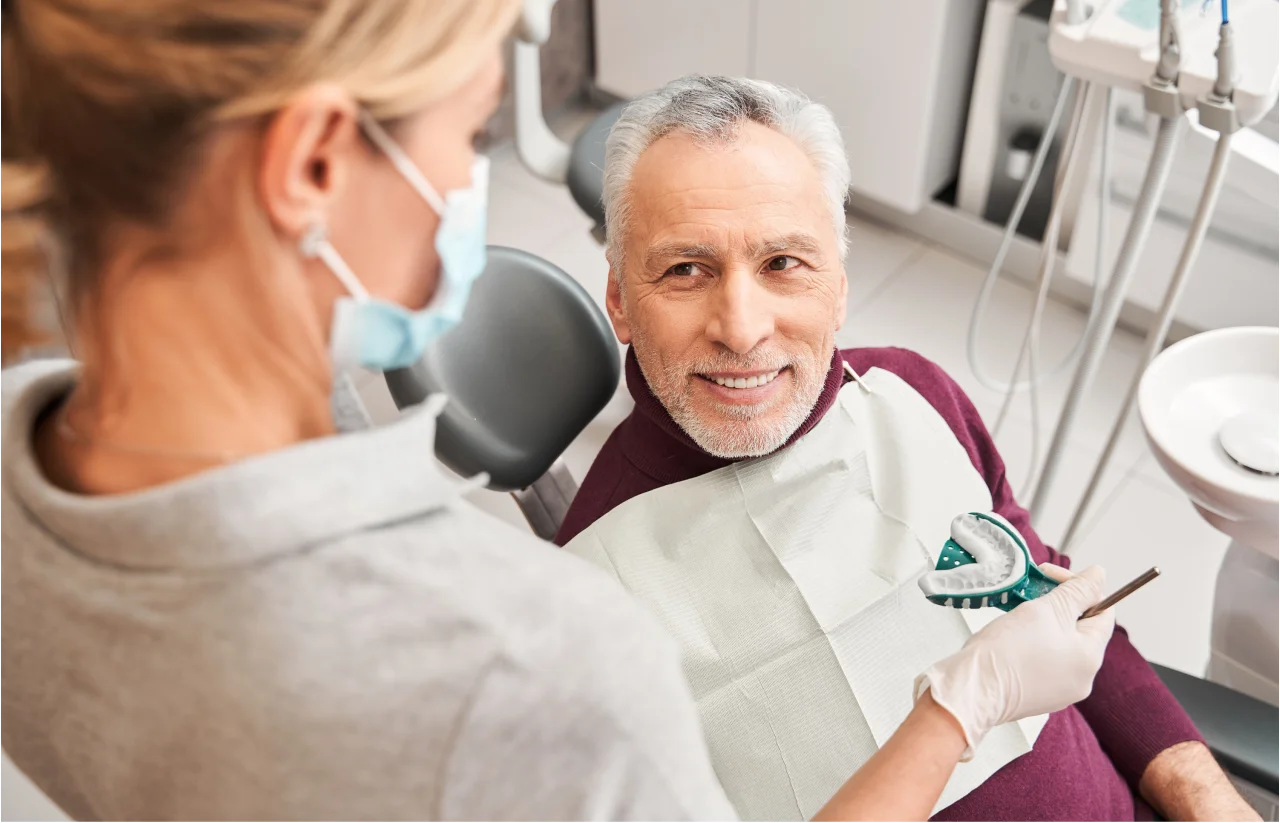 Senior patient consulting with dentist about dentures at Higher Ground Dentistry Upland CA
