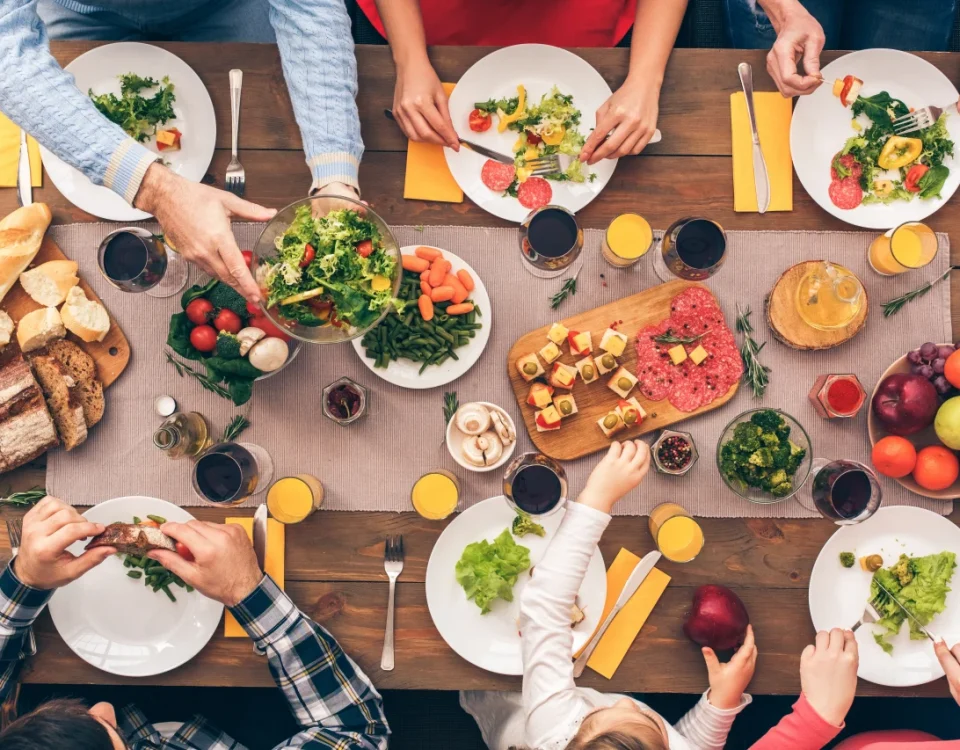 Family sharing a nutritious meal with teeth-healthy foods recommended by a family dentist in Upland CA