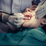 Dr. Sikka performing an oral cancer screening at Higher Ground Dentistry in Upland, CA