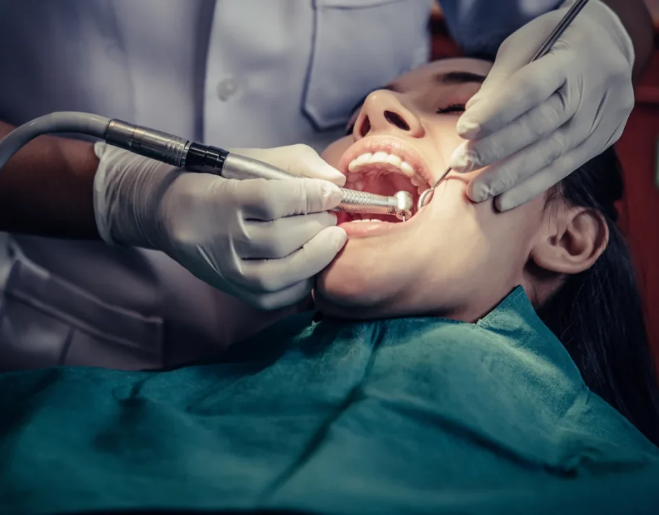 Dr. Sikka performing an oral cancer screening at Higher Ground Dentistry in Upland, CA