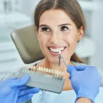Dentist showing teeth shade guide to patient during professional teeth whitening consultation at Higher Ground Dentistry dental office upland ca