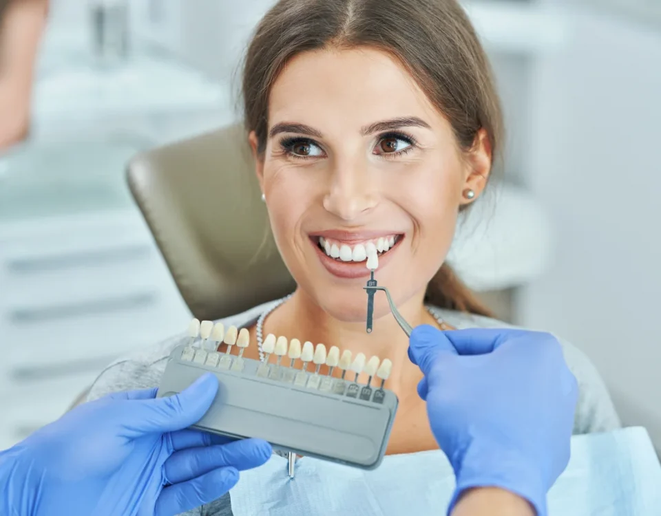 Dentist showing teeth shade guide to patient during professional teeth whitening consultation at Higher Ground Dentistry dental office upland ca