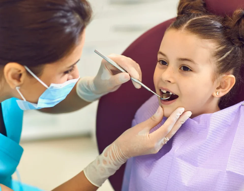 Dentist examining young girl's teeth representing kids dental care upland and cavity prevention upland ca at Higher Ground Dentistry