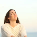 Woman breathing fresh air confidently representing halitosis treatment upland and oral health upland at Higher Ground Dentistry family dentistry upland ca